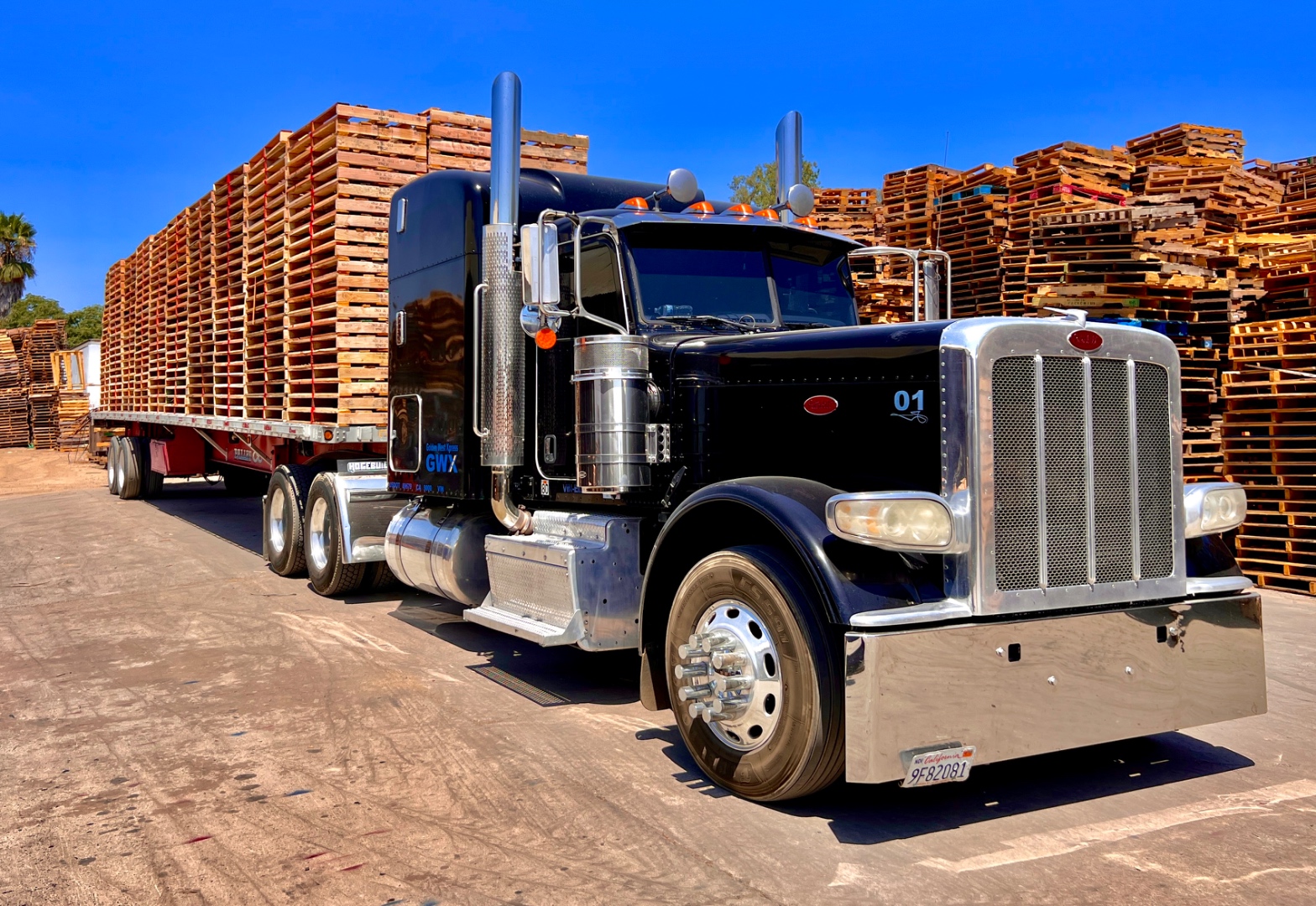 Black Green Valley Pallets Peterbilt truck loaded with pallet stacks in the yard